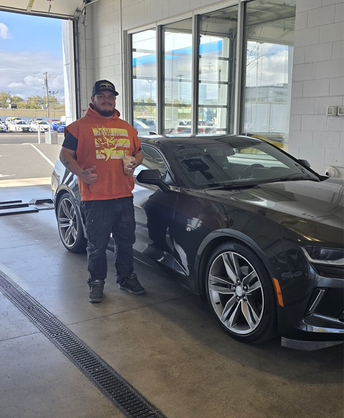 Customer celebrating their vehicle sale at Bud Clary